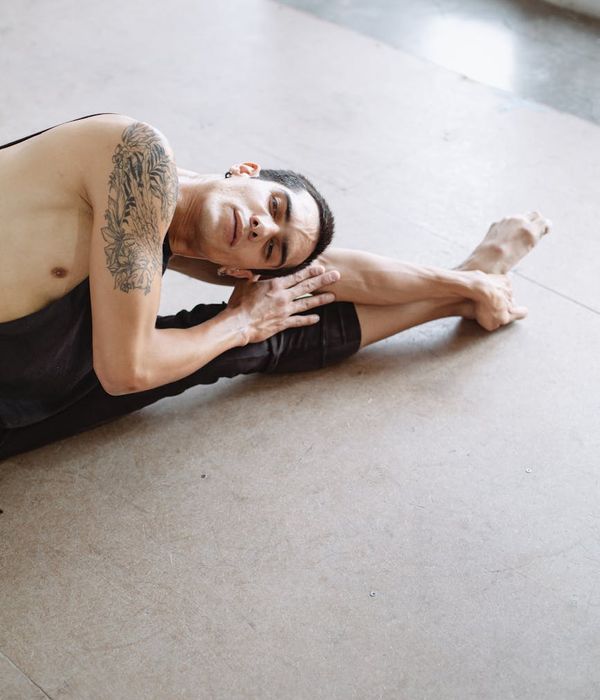 Man performing a stretching exercise, showing flexibility and control.